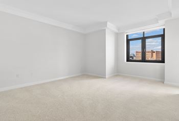 the living room of an empty apartment with a window at HIGHGROVE, Stamford, 06901